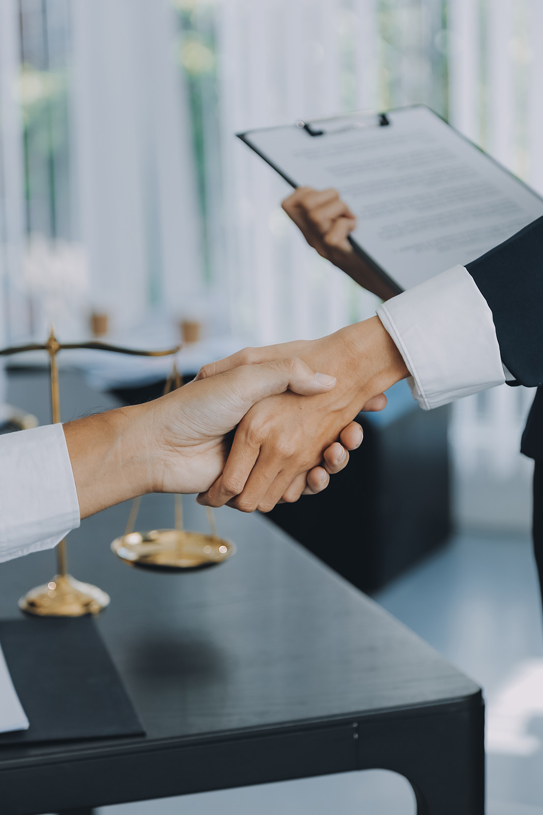 Businessman shaking hands to seal a deal with his partner lawyer