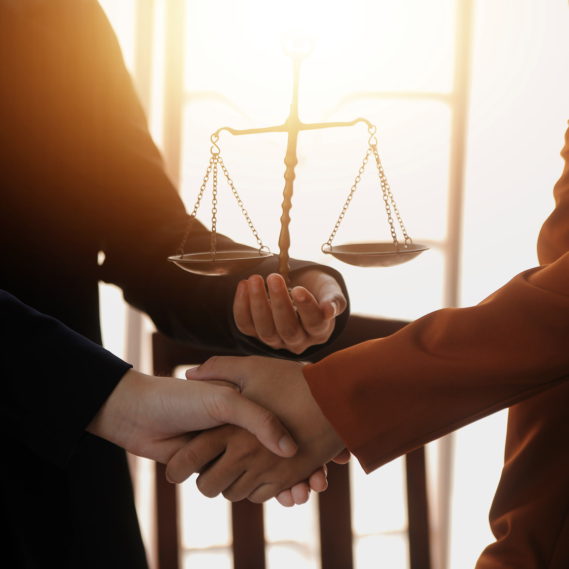 Lawyer shaking hands with a client making about documents, contr